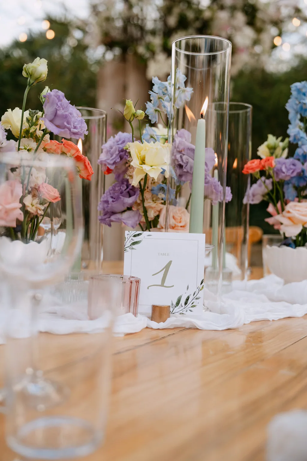 The reception table set with pastel flowers and candlelight