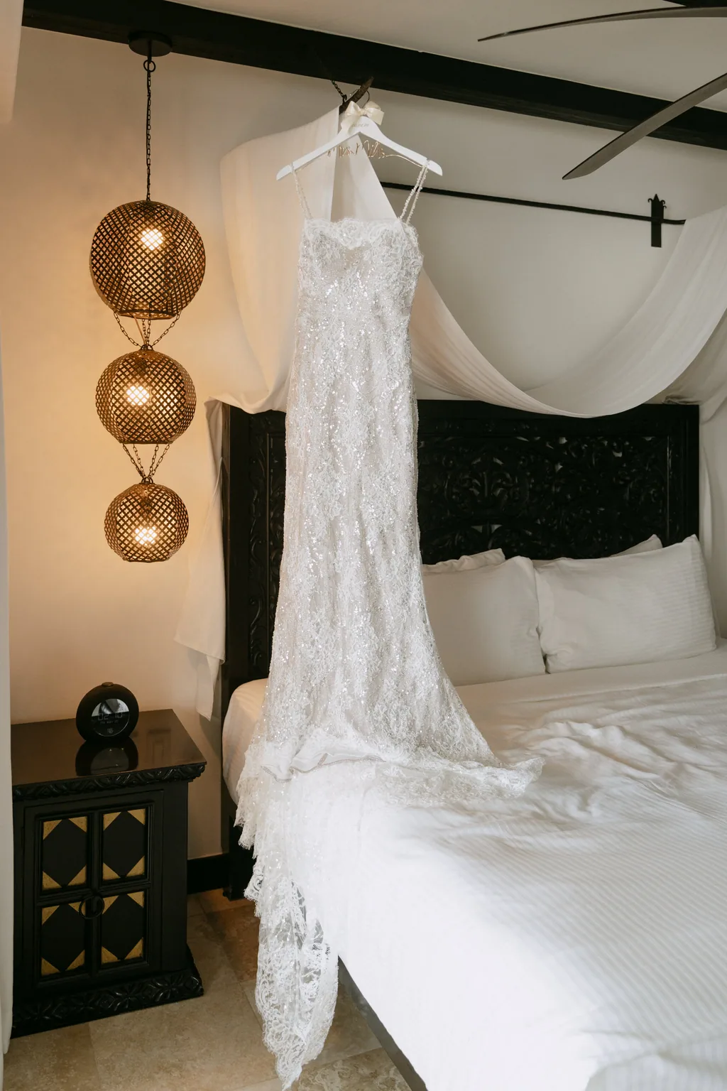 Bailey's wedding dress hanging in the room before she gets ready